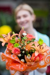 Female florist holding flower bouquet