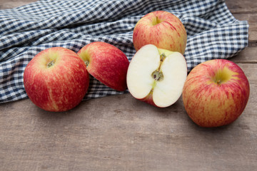 Still life with Red Apples and cloth on a wooden floor.