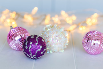 Fototapeta na wymiar Pink, purple and white Christmas decorations with lights 