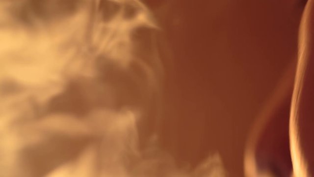 young bearded man smokes a hookah extreme close-up
