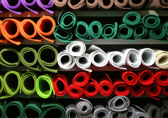 shelf with colored felt rolls for sale in large fabric store
