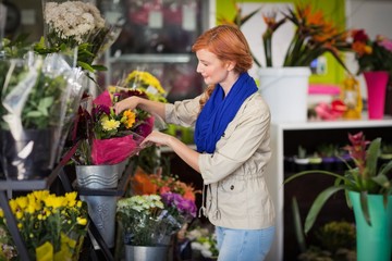 Fototapeta na wymiar Female florist arranging flower bouquet