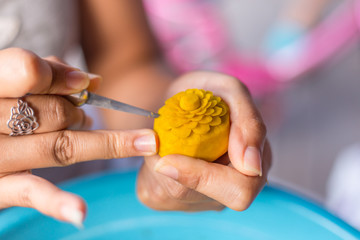 Woman's hand carved pumpkin flowers.