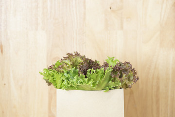 Fresh vegetable in craft paper bag