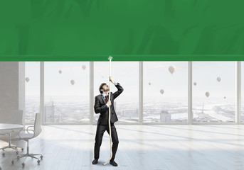 Fototapeta premium Businessman pulling banner . Mixed media