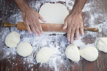 hand moving rolling pin loaf dough wheat