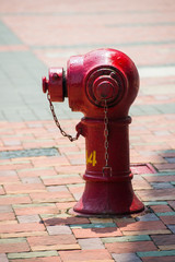 red fire hydrant beside the road in town