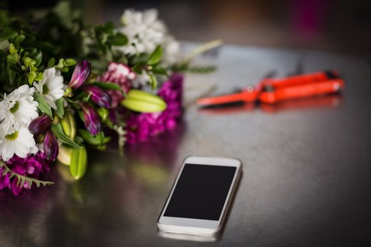 Flowers and smartphone on the table