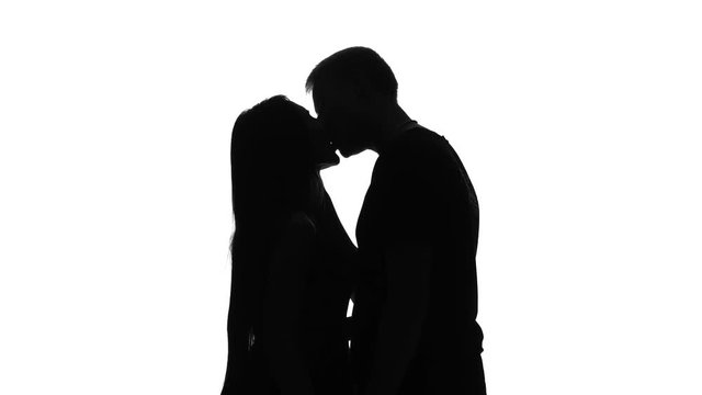 Romantic couple. Portrait of two people kissing. Silhouette. White