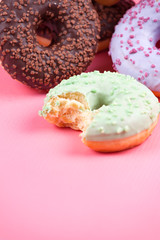 Sweet colorful tasty donuts on pink background.