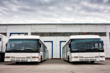 Airport buses in the parking lot near the garages