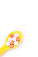 spoon and pills isolated on white background