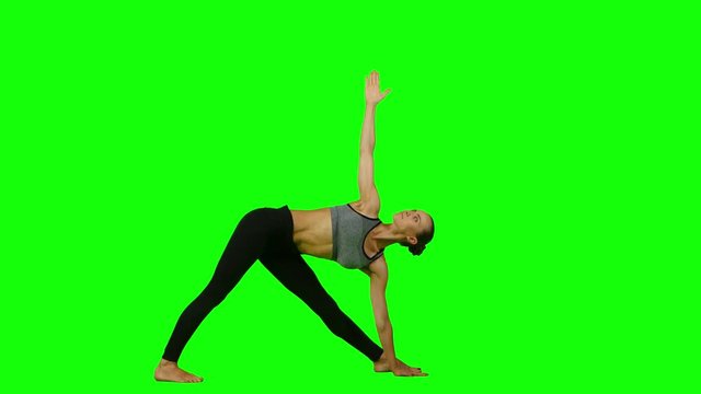 Woman doing yoga in sports clothes. Green screen