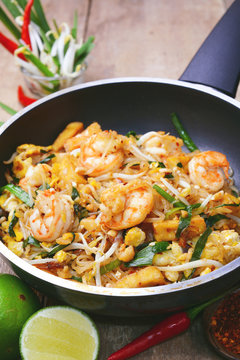 Famous traditional thai food shrimp pad thai, rice noodle stir-fry with prawns, tofu and vegetables on cooking pan.
