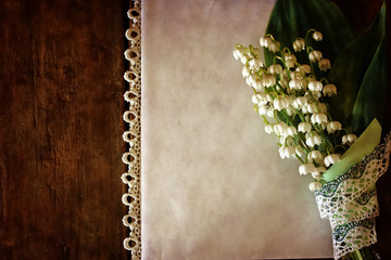 vintage effect on photo bouquet of lilies of the valley and spac