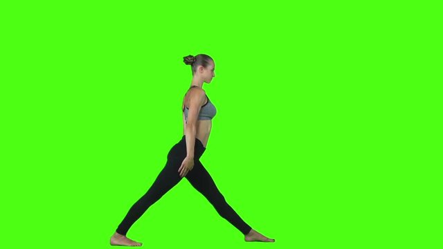 Slim brunette doing yoga. Green screen. Slow motion