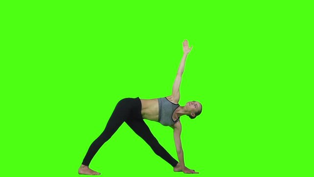 Young woman doing yoga exercise. Green screen. Slow motion