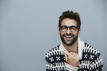 Laughing dude in sweater, studio