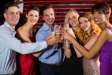 Group of friends toasting glasses of champagne © WavebreakMediaMicro