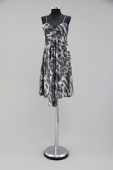 Pattern dress on a model stand against a gray background - 123987738