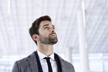 Businessman looking up, content