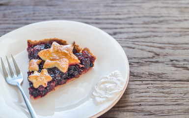 Portion of mince pie on the wooden background