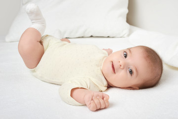 baby portrait lie on white towel in bed