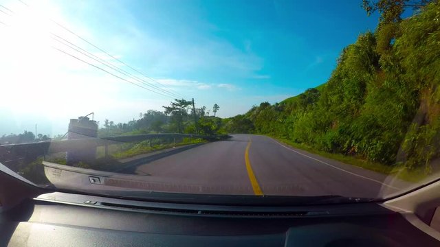 Driving a Car on a Country Road - POV - Point of view front - windshield. Day with sky