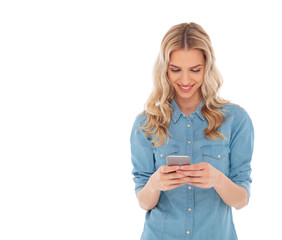 smiling blonde woman is reading text messages on her smartphone