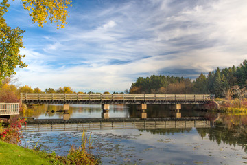 Fototapeta premium Bridge featuring Autumn Vibrant Colors on Apple River