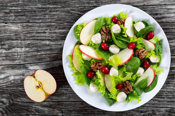 salad of apple, spinach, mini mozzarella balls, lettuce leaves,