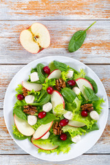 salad of apple, spinach, mini mozzarella balls, lettuce leaves,