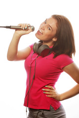 girl  with a microphone singing and having fun