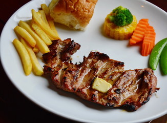 deer steaks and boiled vegetable on white plate