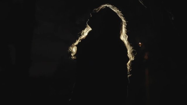 Glow-haired girl dancing at the evil night 
