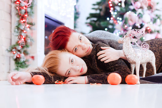 Two girls lay on the floor