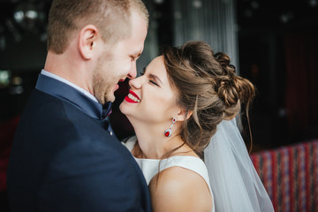 Wedding. Wedding day. Bride and groom after wedding ceremony look at each other and laughing. Close-up.