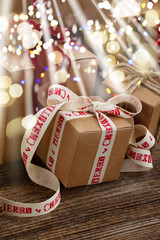 Handmade gift boxes on wooden background close up with glimming bokeh and light