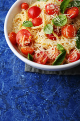 spaghetti with fresh tomato and basil leaves