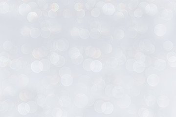 Bokeh soft pastel white background with blurred rainbow lights. Festive background.