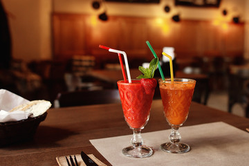 delicious strawberry and carrot fresh smoothie on wooden table,