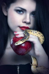 Portrait of a young beautiful woman with a snake.