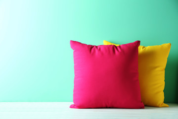 Colorful pillows on a blue wooden table