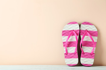 Pair of flip flops on white wooden table