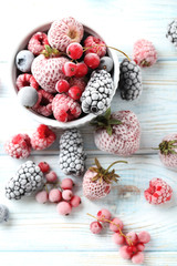 Frozen berries on a white wooden table