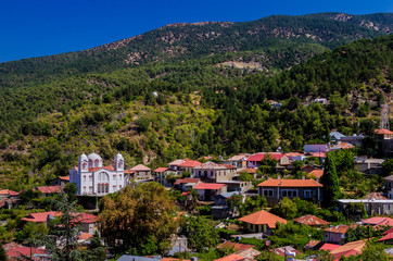 Fototapeta na wymiar White Christian Orthodox church in the mountain village