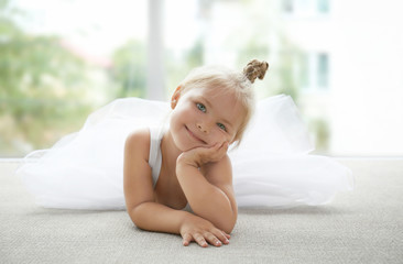 Cute little girl lying in ballet class