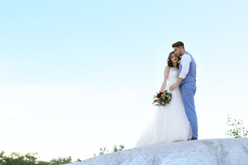 Fototapeta na wymiar Bride and groom standing over beautiful landscape