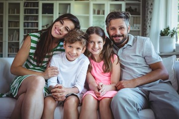Happy family sitting on sofa
