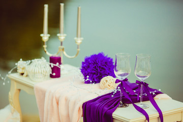 Delicate champagne flutes stand on the white table at the lake s